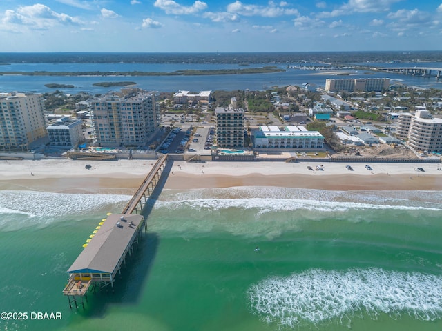 bird's eye view featuring a water view and a beach view