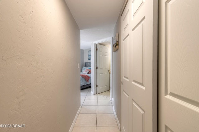 hall featuring light tile patterned floors