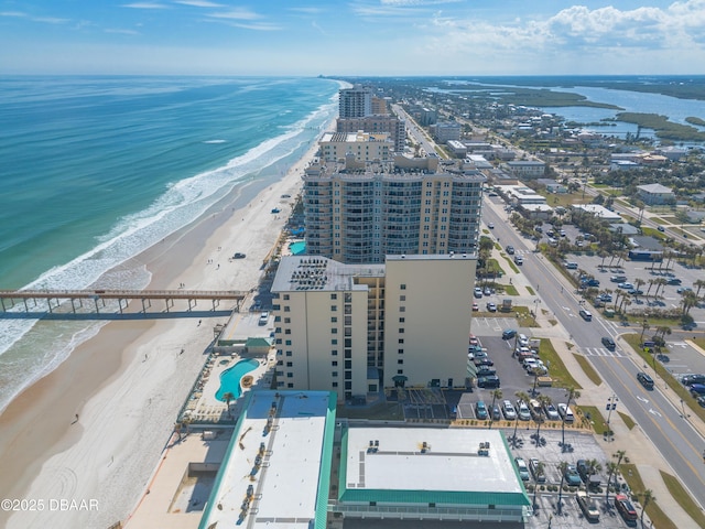 bird's eye view featuring a city view, a view of the beach, and a water view