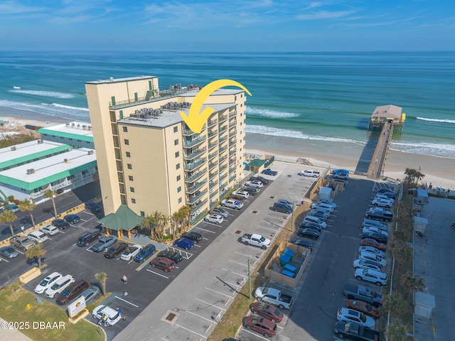 drone / aerial view featuring a view of the beach and a water view