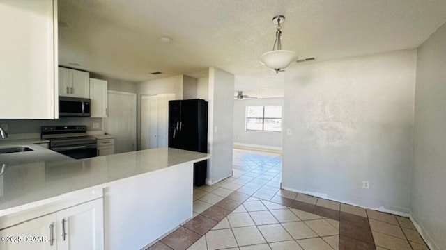 kitchen with baseboards, stainless steel appliances, light tile patterned flooring, white cabinetry, and a sink