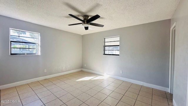 unfurnished room with light tile patterned floors, a textured ceiling, baseboards, and ceiling fan