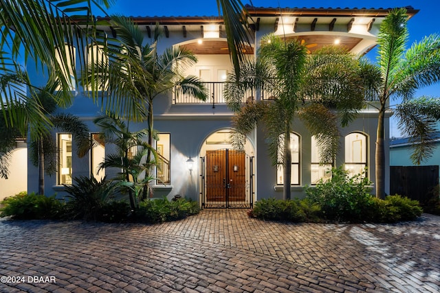 mediterranean / spanish-style home featuring a balcony