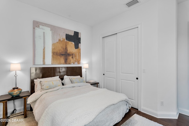 bedroom featuring dark hardwood / wood-style flooring and a closet