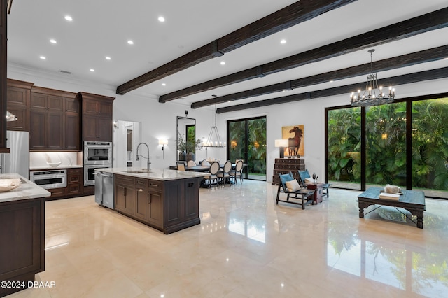 kitchen featuring dark brown cabinetry, sink, decorative light fixtures, a chandelier, and stainless steel appliances