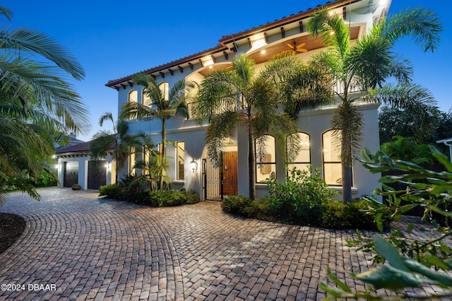 mediterranean / spanish home featuring a garage