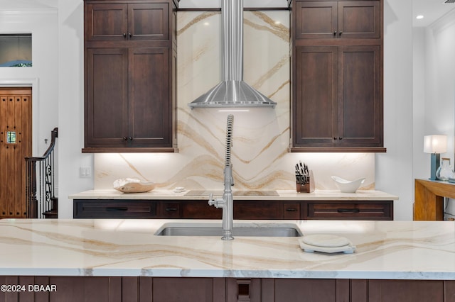 kitchen with light stone counters and dark brown cabinetry