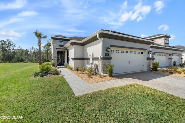 view of front of house with a garage, decorative driveway, stone siding, and stucco siding