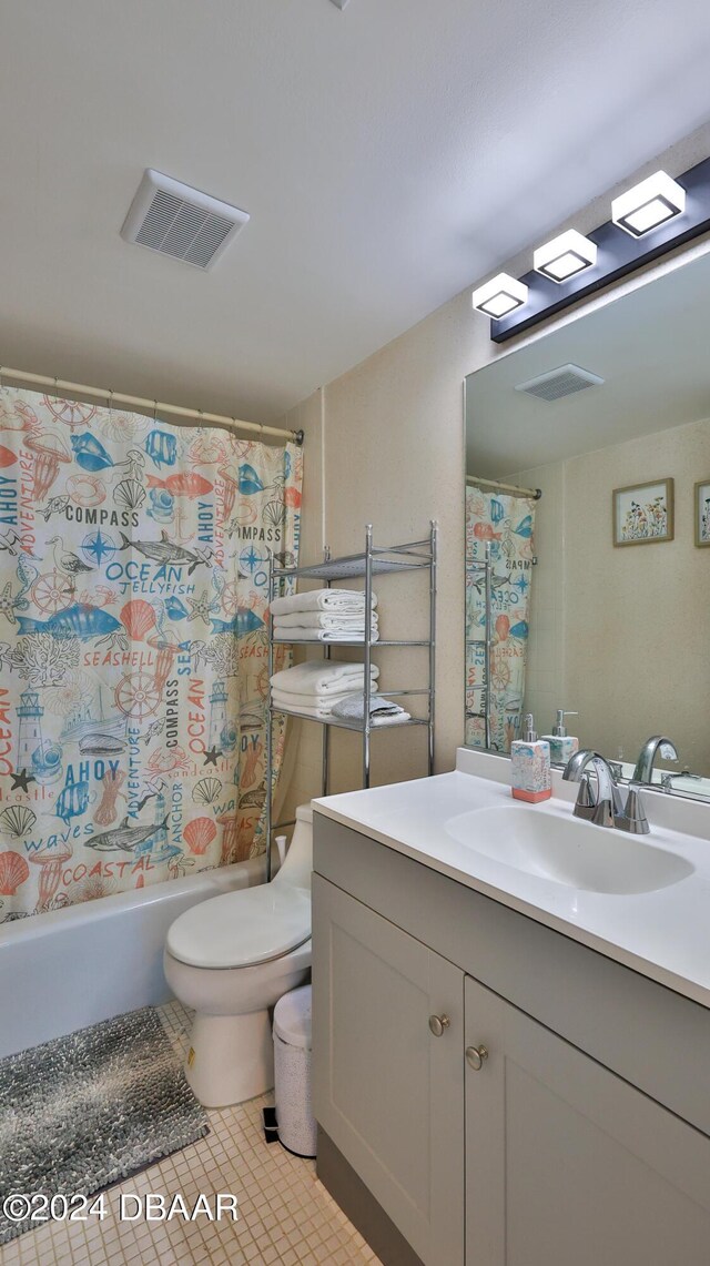 2625 S Atlantic Ave Unit 24Nw, Daytona Beach Shores, FL 32118 - bathroom with vanity, tile patterned flooring, toilet, and shower / tub combo with curtain