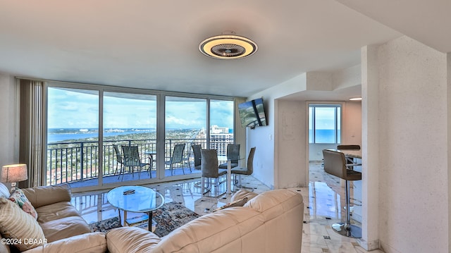 living room featuring expansive windows and a water view