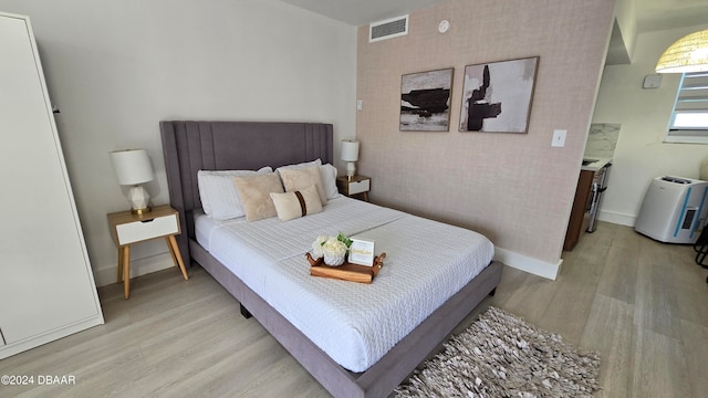 bedroom with light hardwood / wood-style flooring