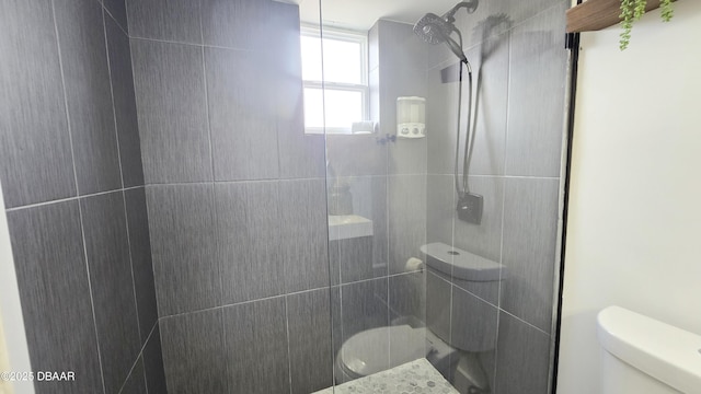 bathroom with toilet and tiled shower