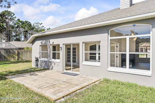 back of property with a patio and a yard