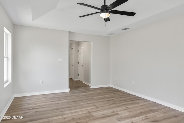 empty room featuring ceiling fan and light hardwood / wood-style floors