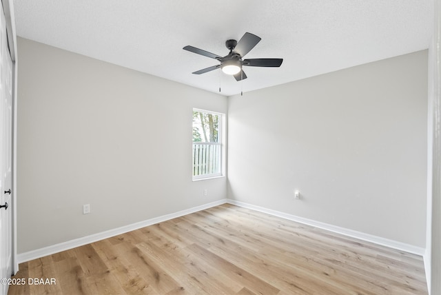 unfurnished room featuring light wood-type flooring and ceiling fan