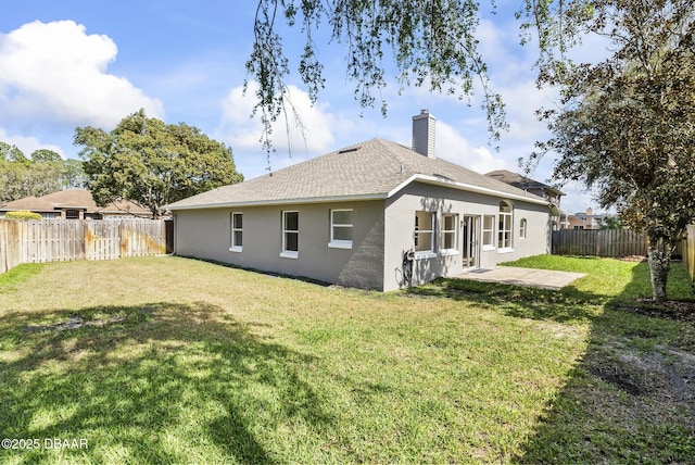 rear view of property with a patio area and a yard