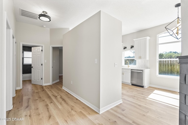 hallway featuring light hardwood / wood-style flooring and sink