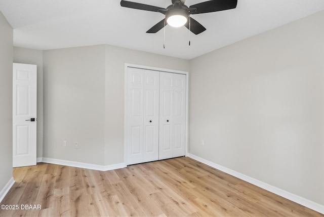 unfurnished bedroom with ceiling fan, light hardwood / wood-style floors, and a closet