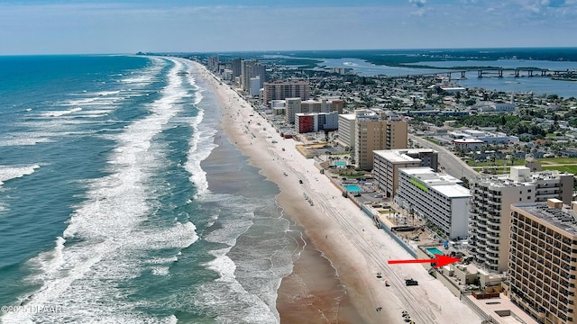 drone / aerial view with a water view and a beach view