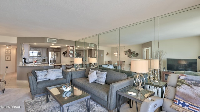 living room featuring light tile patterned floors and a textured ceiling