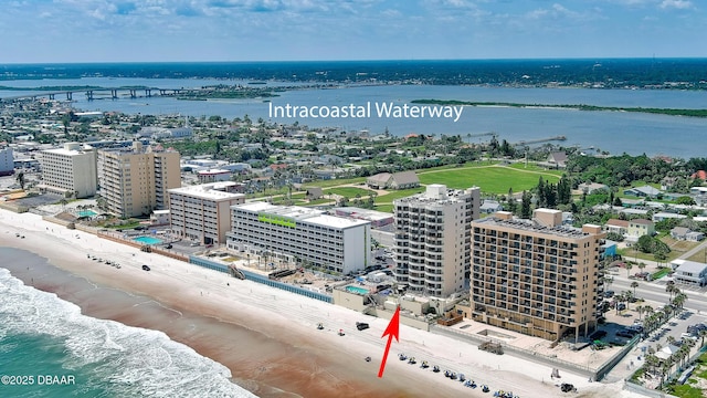 drone / aerial view with a water view and a view of the beach