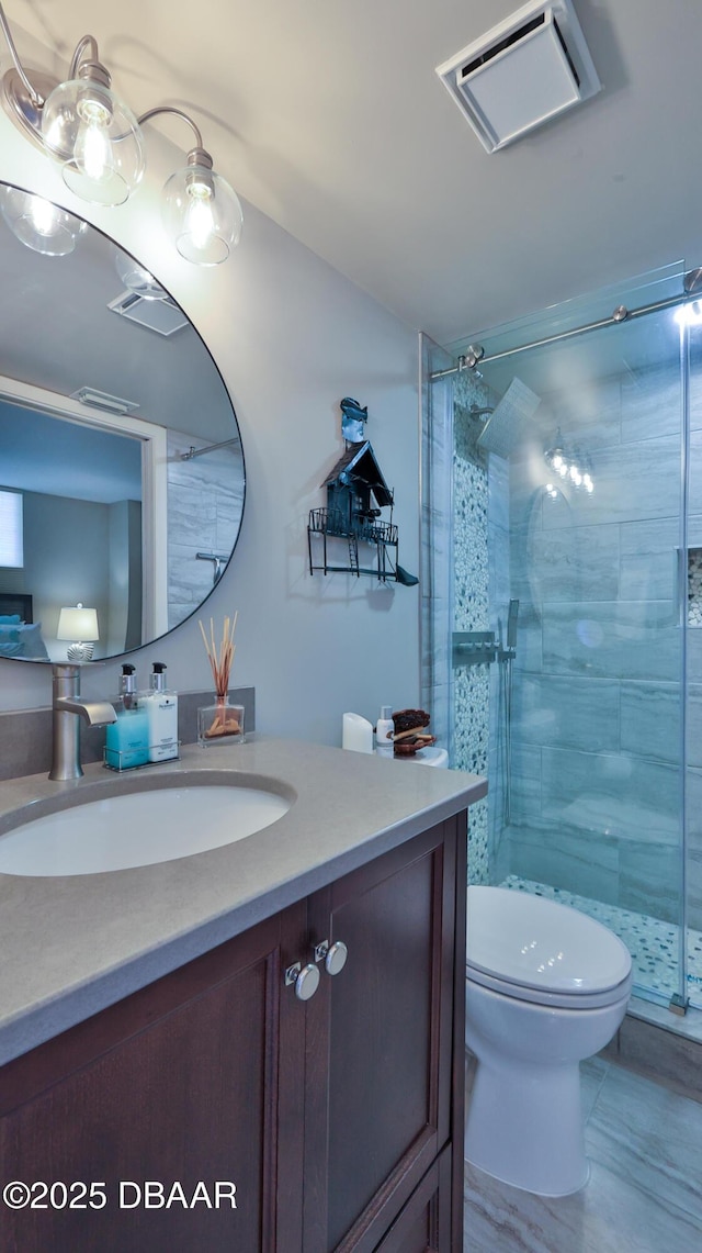 bathroom featuring vanity, toilet, and walk in shower