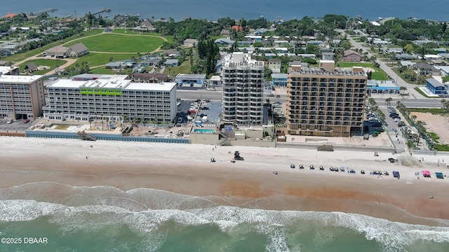 drone / aerial view with a water view and a view of the beach