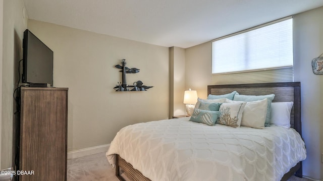 bedroom featuring light colored carpet