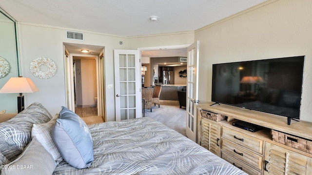 carpeted bedroom featuring french doors, ornamental molding, and stainless steel refrigerator with ice dispenser