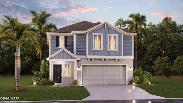 view of front of home with a lawn and a garage