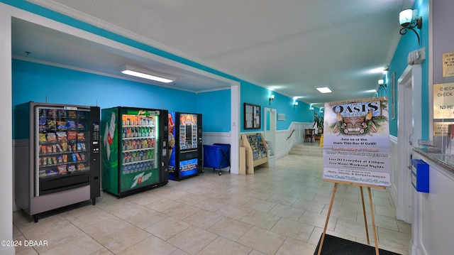 313 S Atlantic Ave Unit 413, Daytona Beach, FL 32118 - corridor with a wainscoted wall, stairs, and tile patterned floors