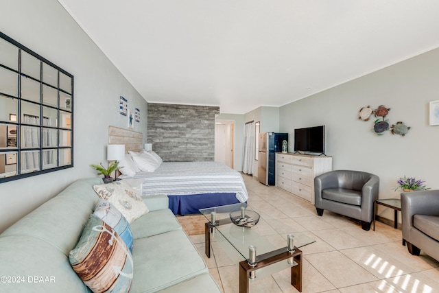 bedroom with stainless steel refrigerator and light tile patterned floors