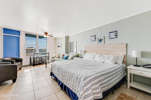 bedroom with ornamental molding, light tile patterned flooring, and ceiling fan