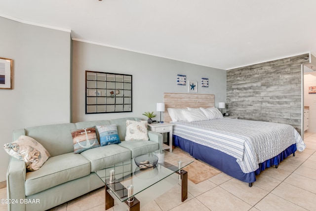 bedroom with light tile patterned floors and crown molding