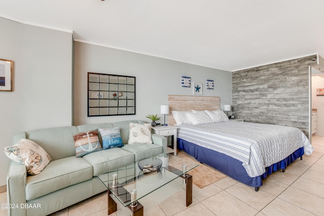 313 S Atlantic Ave Unit 413, Daytona Beach, FL 32118 - bedroom with light tile patterned flooring, crown molding, and an accent wall
