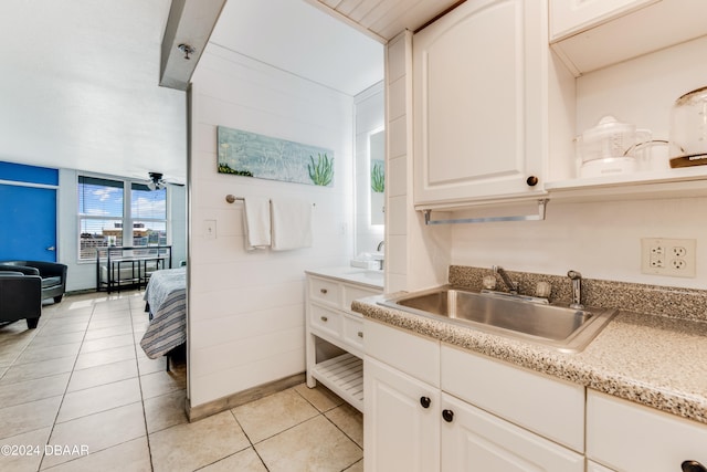 bathroom featuring ceiling fan, tile patterned flooring, and sink