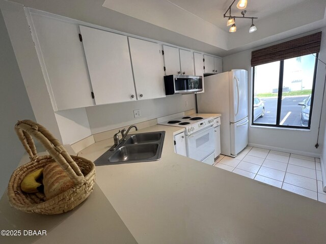 kitchen featuring light tile patterned flooring, white appliances, and sink