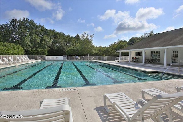 1323 Cork Dr, Ormond Beach, FL 32174 - community pool with a patio area and view of scattered trees