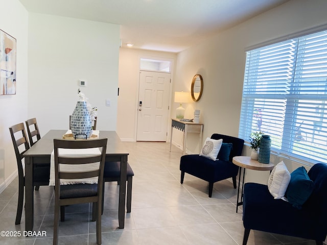 1323 Cork Dr, Ormond Beach, FL 32174 - dining area featuring plenty of natural light, light tile patterned flooring, and baseboards