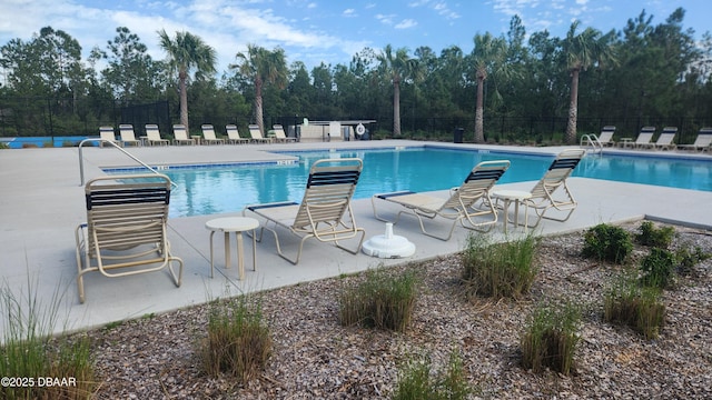 3103 Nova Scotia Way, New Smyrna Beach, FL 32168 - community pool with view of wooded area and a patio area