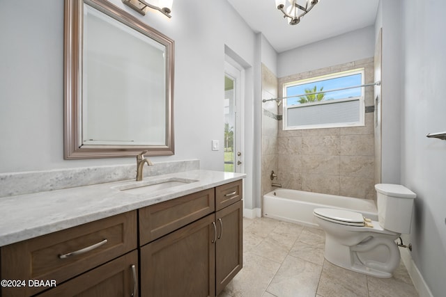 full bathroom featuring vanity, tiled shower / bath combo, and toilet