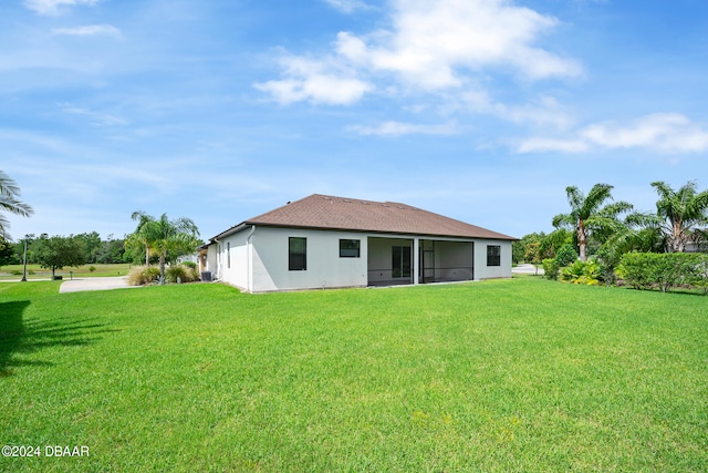 rear view of property with a yard