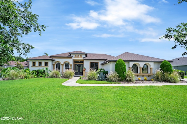 mediterranean / spanish-style home with a front yard