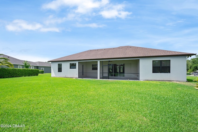 back of house featuring a lawn