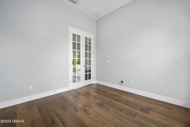 empty room featuring french doors and hardwood / wood-style flooring