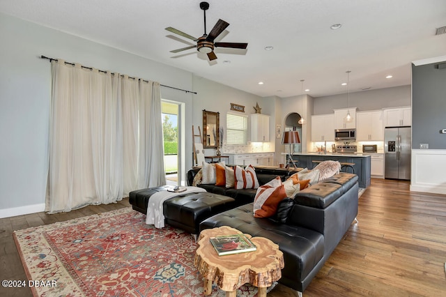 living room with hardwood / wood-style flooring and ceiling fan