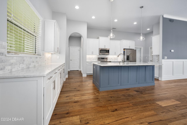 kitchen with white cabinetry, decorative light fixtures, and stainless steel appliances