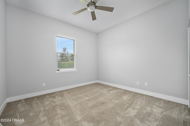 spare room featuring carpet flooring and ceiling fan