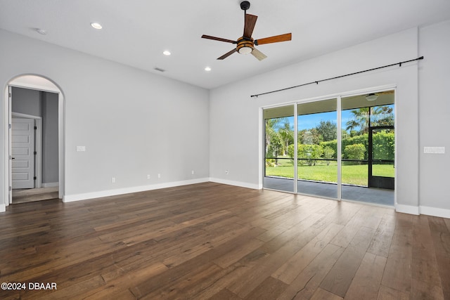 unfurnished room featuring dark wood-type flooring and ceiling fan