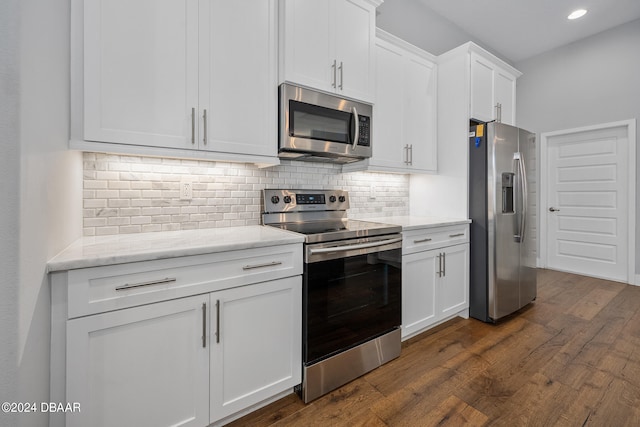 kitchen with appliances with stainless steel finishes, light stone countertops, dark hardwood / wood-style floors, white cabinets, and decorative backsplash